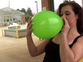 Fifi foxx blows and pops balloons outdoors