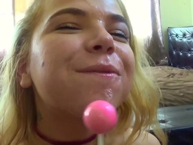 Petite blonde sucks her lollipop
