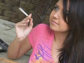 Holding a cigarette and teasing her friend