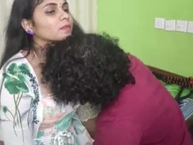Sultry Indian housewife in bed with her young lover, exchanging devoted kisses added to teasing caresses that ignite frolicsome passion.