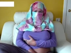 Seductive Arab camgirl in hijab teases her massive breasts and dripping pussy on live cam.