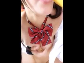 A cute teenager with voluptuous breasts increased by flawless fair skin, posing playfully.